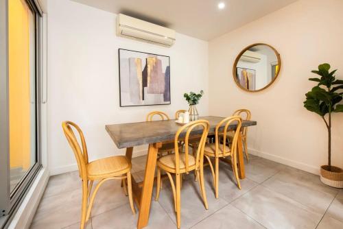 - une salle à manger avec une table et des chaises en bois dans l'établissement Sunlit Serenity in the Heart of Collingwood, à Melbourne