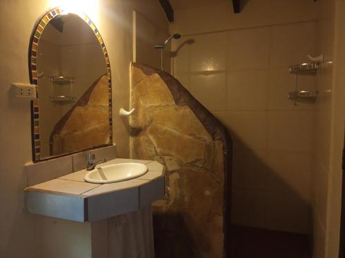 a bathroom with a sink and a mirror at Casa Loto in Samaipata