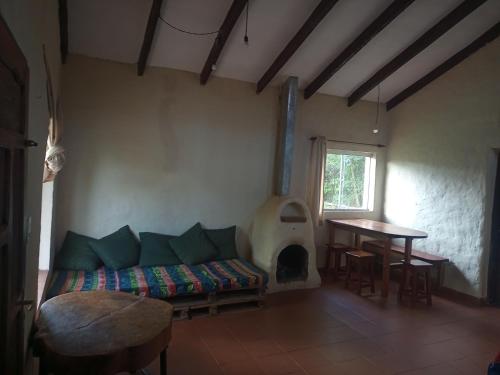 ein Wohnzimmer mit einem Sofa und einem Kamin in der Unterkunft Casa Loto in Samaipata