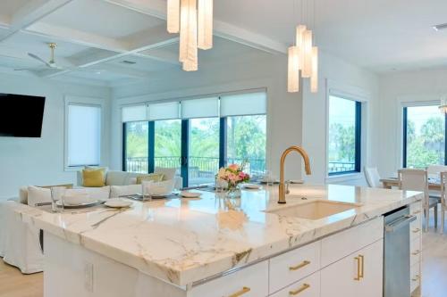 a kitchen with a large island with a sink at Tropical Gulf View Estate - Anna Maria, FL in Anna Maria