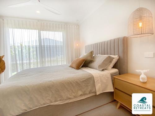 a bedroom with a bed with a large window at Pembrey Perfection in Cowes
