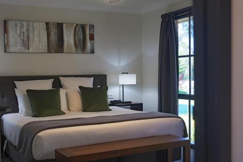 a bedroom with a large bed and a window at Yarra Gables in Healesville