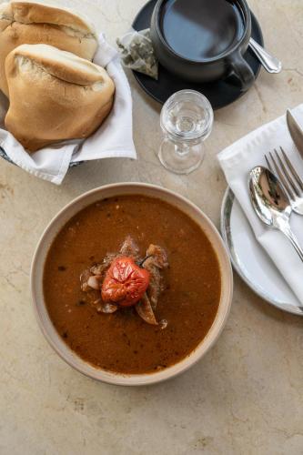 a bowl of soup sitting on top of a table at La Posada del Puente in Arequipa