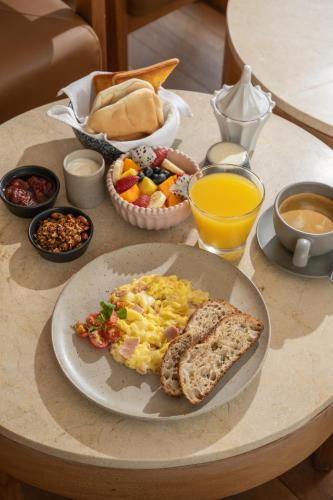 a breakfast table with a plate of eggs and toast at La Posada del Puente in Arequipa