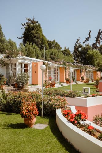 a row of houses with flowers in the yard at La Posada del Puente in Arequipa