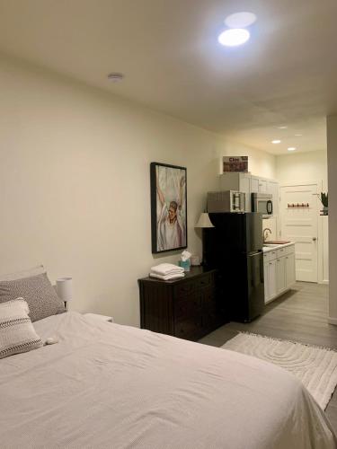 a bedroom with a bed and a kitchen with a refrigerator at The Asbury House Guest Rentals in Moscow