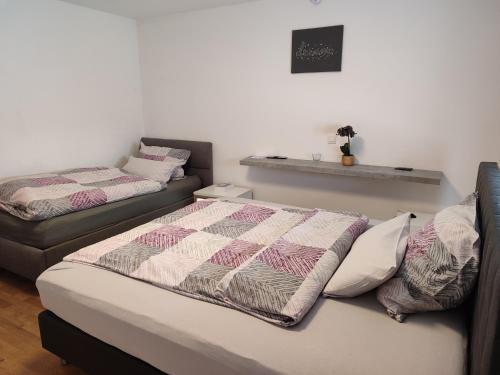 a bedroom with two beds and a couch at Ferienwohnung Rhein-Main II in Flörsheim am Main