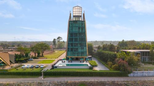 a building with a tower on top of it at Naka-Raj Escape Hotel in Nakhon Phanom