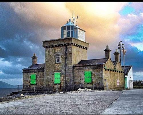 a building with a clock tower on top of it at New 3 bedroom apartment by the beach Belmullet. in Belmullet