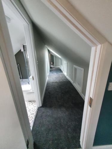 an empty hallway of an apartment with a hallway leading into a room at New 3 bedroom apartment by the beach Belmullet. in Belmullet