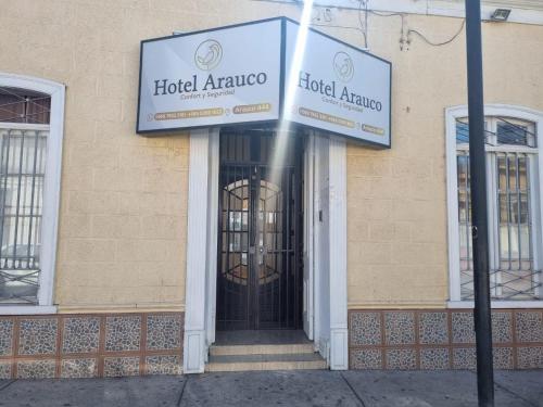 un edificio con una puerta con un cartel. en Ovalle Hotel Arauco, en Ovalle