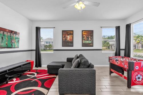 a living room with a couch and a table at Upstay - Sonoma Resort Home w Private Pool in Kissimmee