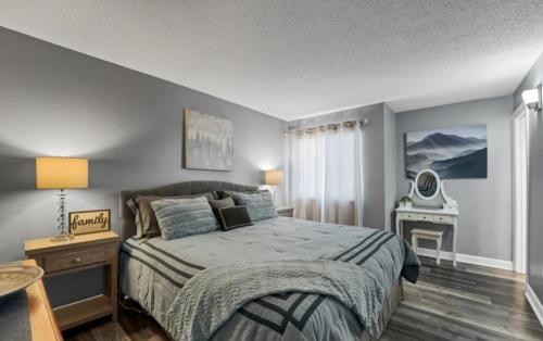 a bedroom with a large bed and a desk at NEW- Lovely 2-Bdr2Bath Gatlinburg Condo with resort indoor pool hot tub Wi-fi, great location in Gatlinburg