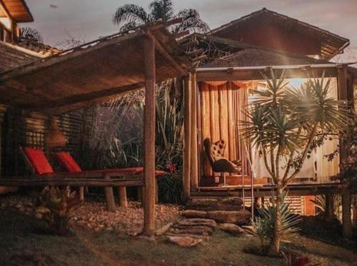 a dog sitting on a porch of a house at Canto dos Prazeres Lavras Novas in Lavras Novas