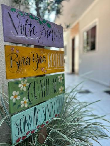 a group of signs that say welcome to a house at BORA BORA RESIDENCE in Joinville