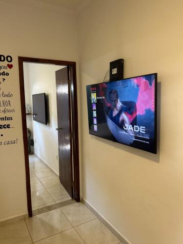 a flat screen tv hanging on a wall at BORA BORA RESIDENCE in Joinville