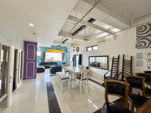 a living room with a dining room table and chairs at Araha Resort Arapana in Chatan