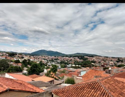 a view of a city with roofs and mountains at Pousada Malu in Bragança Paulista