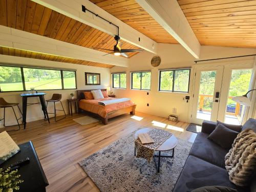 a living room with a bed and a couch at A Restful Studio Near a Creek and Forest - Pet Friendly in Roseburg