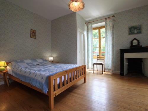 ein Schlafzimmer mit einem großen Bett und einem Kamin in der Unterkunft Gîte Saint-Didier-sur-Doulon, 5 pièces, 8 personnes - FR-1-582-222 in Saint-Didier-sur-Doulon