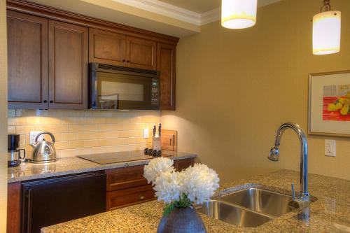 a kitchen with a sink and a vase of flowers at Oak Bay Beach Hotel in Victoria