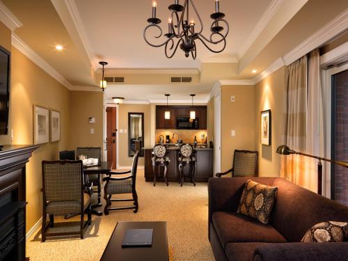 a living room with a couch and a dining room at Oak Bay Beach Hotel in Victoria