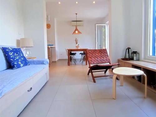 a living room with a couch and a chair and a table at Apartments by the sea Sobra, Mljet - 22329 in Babino Polje