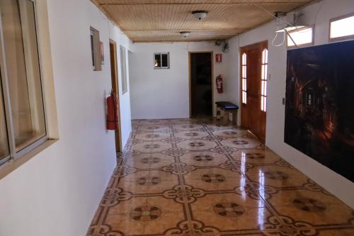 a hallway with a tiled floor in a building at el valle in Calama