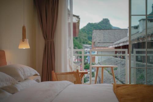 a hotel room with a view of a balcony at Leye Inn in Yangshuo