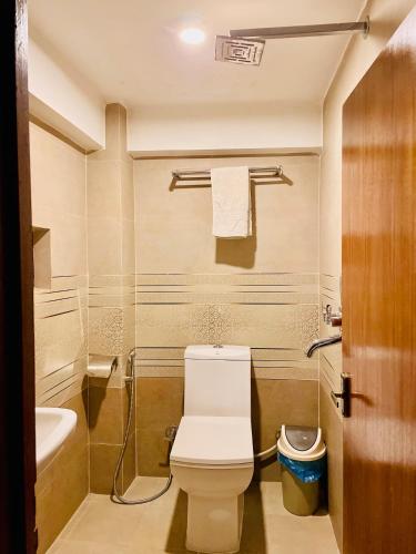 a bathroom with a white toilet and a sink at Hotel vintage Home in Bhaktapur