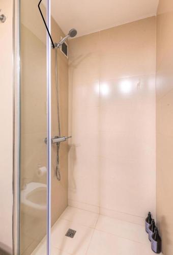 a shower with a glass door in a bathroom at jerusalemvip in El Muṣrāra