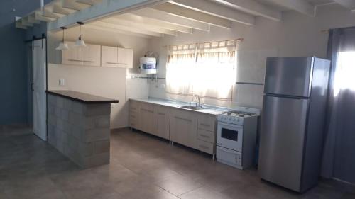 a kitchen with a refrigerator and a sink in it at Quinta elescano in Junín