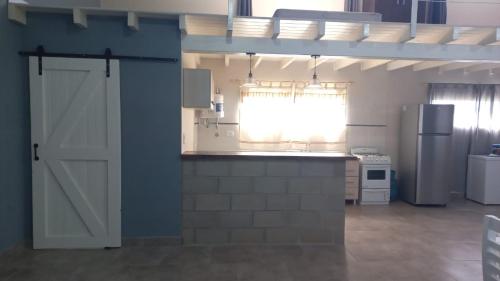 a kitchen with a white door and a refrigerator at Quinta elescano in Junín