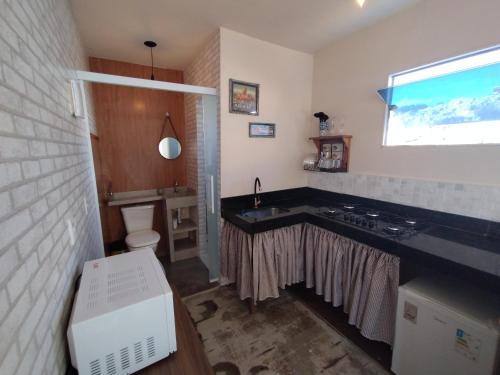 a bathroom with a sink and a toilet in it at Recanto das Pedras - Loft Container in São Thomé das Letras