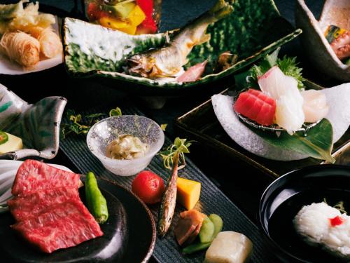 a table topped with different types of food on plates at Nara Royal Hotel in Nara