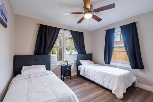 a bedroom with two beds and a ceiling fan at Serenity In Sarasota in Sarasota