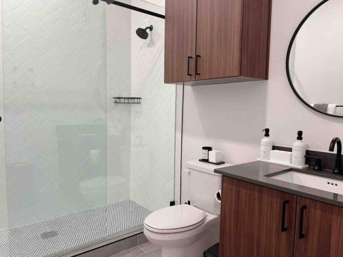 a bathroom with a toilet and a glass shower at Luxury Condo in Prime Location (Pet-Friendly) in New Braunfels