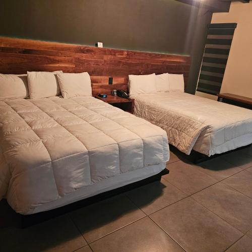 Postel nebo postele na pokoji v ubytování HOTEL RIO RITA