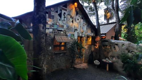 a building with a bunch of pictures on the side of it at Camping Nomadas in Bonito
