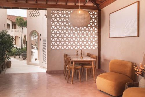 a dining room with a table and a chair at Dune Seseh in Munggu