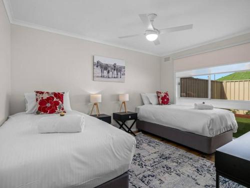 a bedroom with two beds and a window at Nook on Nixon in Shepparton