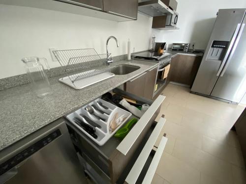 a kitchen with a sink and a counter top at Departamento 1 habitación - Latitud La Victoria a 5 minutos del centro in Querétaro