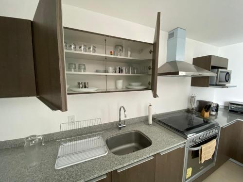 a kitchen with a sink and a counter top at Departamento 1 habitación - Latitud La Victoria a 5 minutos del centro in Querétaro