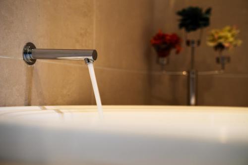 a faucet with water coming out of it in a bathroom at Yarra Valley Serenity House in Golf Course Resort in Wonga Park