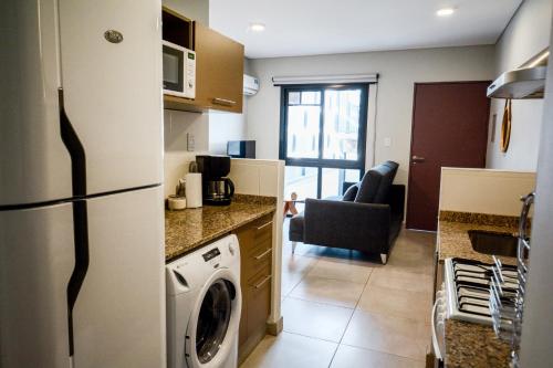 a kitchen with a refrigerator and a washer at 4) Hermoso departamento cómodo y equipado! in Godoy Cruz