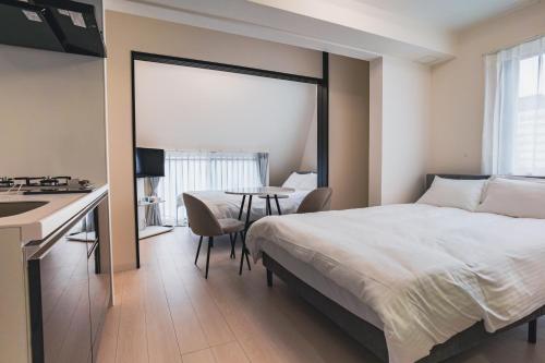 Postel nebo postele na pokoji v ubytování Star Residence - 博多上呉服