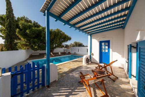 a patio with two chairs and a swimming pool at ALYKI'S FAMILY POOL Villa in Aliki