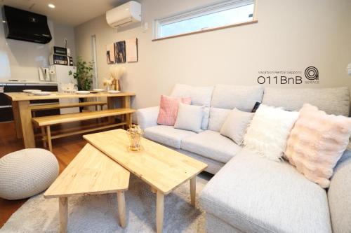 a living room with a couch and a table at YI HOUSE MAX 8people 2BR 1 minute walk from tram station in Sapporo