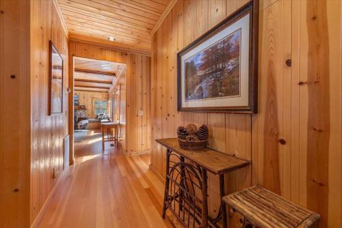 a hallway of a wooden cabin with a picture on the wall at Cozy Designer Decorated Cabin Near Slopes Fireplace Peekaboo Lakeview in Carnelian Bay