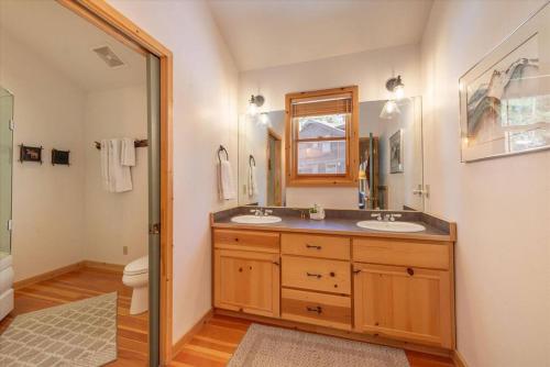a bathroom with two sinks and a toilet at Spacious, Central, & Cozy Cabin Near Lake & Trails in Carnelian Bay